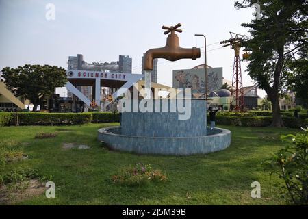 Giant Magic Tap, an outdoor floating tap fountain hovering above a pool, with endless supply of water gushing out of it, seemingly from nowhere. Scien Stock Photo