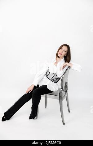 Stylish attractive woman look at the camera, posing in formal wear. Beautiful elegant business lady at the studio. Successful confident female on the Stock Photo