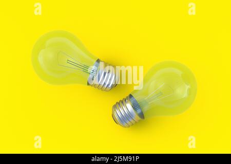 Two light bulbs on yellow background. Top view. 3d render Stock Photo