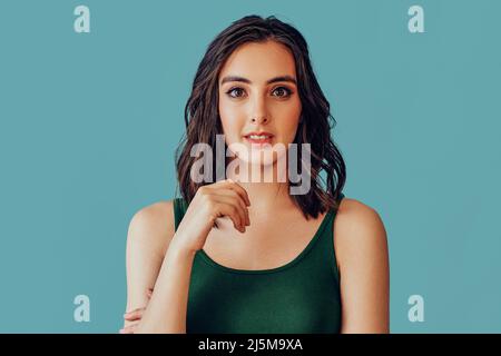 Concentrated young woman looking at camera studio portrait Stock Photo