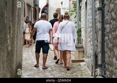 Tourists walking through the historic old town of Krk in Croatia Stock Photo