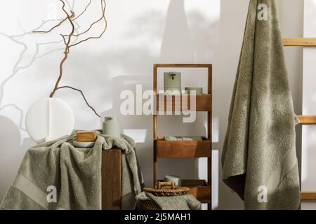 https://l450v.alamy.com/450v/2j5mah1/modern-aesthetic-bathroom-accessories-in-eucalyptus-green-shade-organic-cotton-bath-towels-sensor-soap-and-lotion-dispenser-on-solid-oak-stump-dai-2j5mah1.jpg