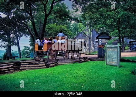 June 22, 1992 Branson, Missouri USA: A horse drawn wagon takes tourists on a tour of the Shepherd of the Hills homestead near Branson, Missouri. The site is the setting of the famous book, 'Shepherd of the Hills'. Stock Photo