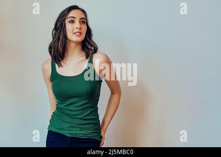Woman with hands on pockets looking to the side at copy space studio portrait Stock Photo