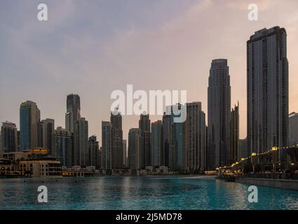 DUBAI, U.A.E - April 20 2022: Panoramic view of the Dubai mall and the Dubai Fountain captured in the evening. The Dubai Mall is the largest mall in t Stock Photo