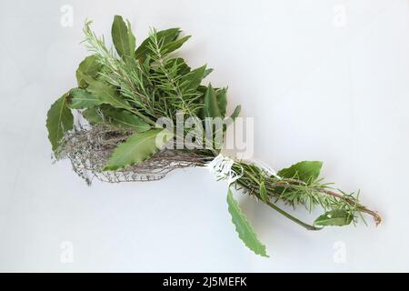 garnished bouquet, bundle of herbs, speciality of french cuisine, on white background, top view Stock Photo