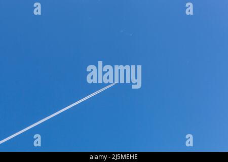 airplane moving over the blue sky background Stock Photo