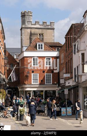 Red brick Grade II listed buildings 18-19 on The Square. Shops, cafes and pedestrians shopping in the historic centre of Winchester. England Stock Photo