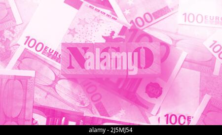 Word NGO non-governmental organization on a wooden cubes on a money background. Social business concept. Stock Photo