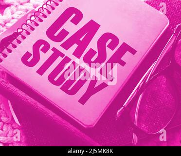 Case study memo written on a notebook with pen, glasses on crochet cloth. Successful business cases educational concept Stock Photo