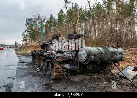 2022-04-09 Kyiv region, Ukraine. Destroyed russian tank sucked in the mud on the E40 highway near Kyiv. War in Ukraine Stock Photo