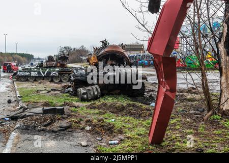 2022-04-09 Kyiv region, Ukraine. Remains of russian tanks with V tactical marking on the E40 highway near Kyiv. War in Ukraine Stock Photo