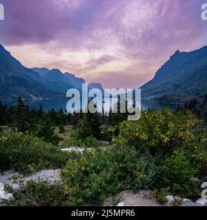 Purple Clouds Over Wild Goose Island At Sunrise in Glacier National Park Stock Photo