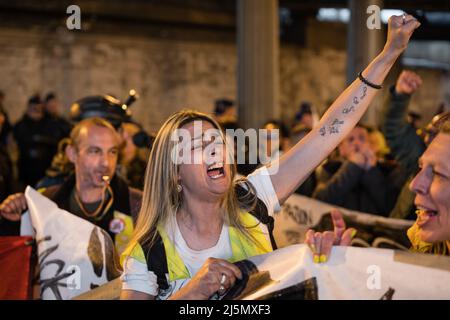 Paris, France. 23rd Apr, 2022. Protester against the French system raises her fist during the demonstration. Demonstration on the streets of Paris, France, a day before the presidential elections between Emmanuel Macron and Mariane Le Pen. The protesters show their discontent with both political options. Credit: SOPA Images Limited/Alamy Live News Stock Photo