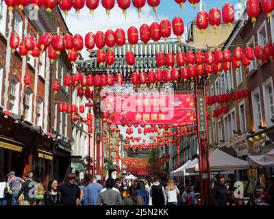 A view along Gerrard Street in London's Chinatown decorated with hanging red lanterns Stock Photo