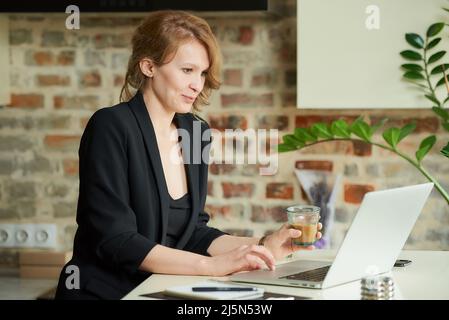 A boss listening to a discussion of a project with employees at a video call. Stock Photo