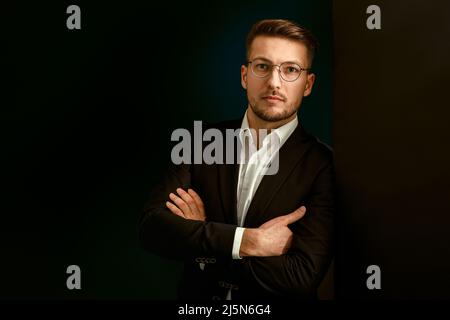 Portrait of a businessman in a suit on a dark background. Stock Photo