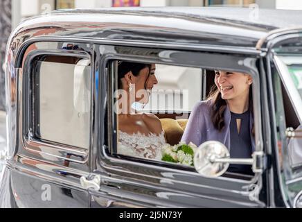 A bride and a bridesmaid in an antique car Stock Photo
