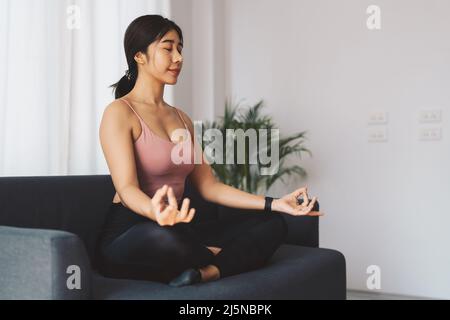 Mindfulness and meditation. Young relaxed fitness woman practice