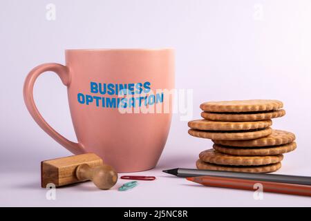 Business Optimisation concept. Coffee mug with text on a white background. Stock Photo
