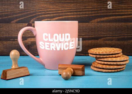 Cloud Service. Coffee mug with text on the office desk. Stock Photo