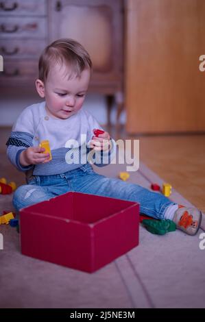 Portrait of cute little boy playing on the floor Stock Photo