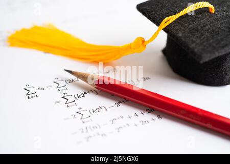 Graduation gap hat and pencil on mathematic formula exercise test paper in education school. Stock Photo