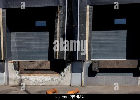 trucks at loading ramps of a warehouse. two  storage gates for trucks. Stock Photo