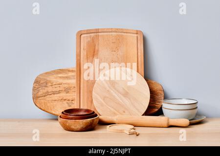 Image of wooden cutting boards and bowls on table in kitchen Stock Photo