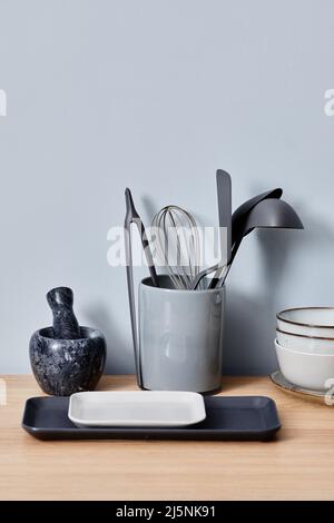 Image of kitchenware with little trays and bowls preparing for cooking on table Stock Photo