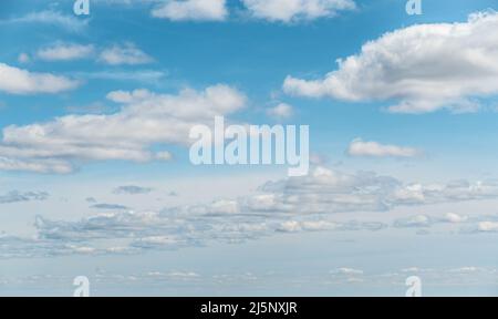 white cloud on blue sky. some white whispy clouds and blue sky cloudscape. Beautiful blue sky and clouds natural background. Blue sky and white fluffy Stock Photo
