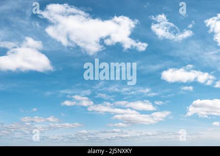 some white whispy clouds and blue sky cloudscape. blue sky with white cloud background. turquoise sky with different types of clouds. Stock Photo