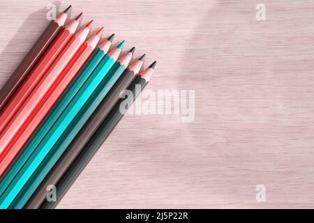Pastel cyan colored pencils on the wooden table. Arts and leisure activity and hobby backgrounds Stock Photo