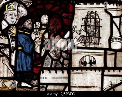 Medieval stained glass fragments depicting a prison scene from the legend of St Andrew and St Matthew, St Andrews church, Greystoke, Cumbria, UK Stock Photo