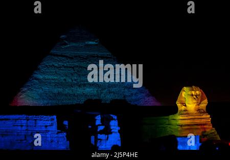 The Pyramid of Khafre and the Great Sphinx illuminated during the Pyramids Sound & Light show on the Giza plateau at Cairo in Egypt. Stock Photo