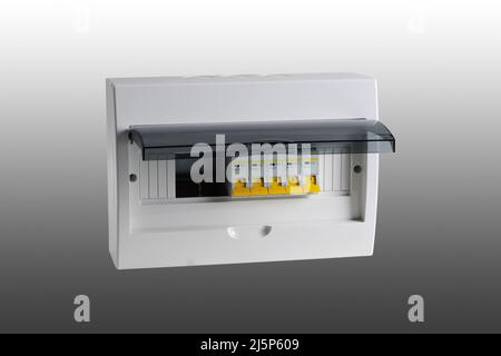 Plastic distribution board. Electrical board. Close-up. Isolated on gray background. Stock Photo