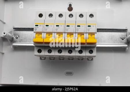 Protective electric devices on a din rail. Stock Photo
