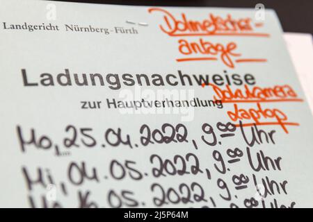 Nuremberg, Germany. 25th Apr, 2022. "Proof of charge" is written on a folder at the start of the trial in the courtroom of the Criminal Justice Center of the Nuremberg-Fürth Regional Court. The prosecution accuses a 30-year-old man of attempted murder and dangerous bodily harm. He allegedly knocked a sleeping 20-year-old to the ground and kicked him several times in the head in September 2021 due to delusions. Credit: Daniel Karmann/dpa/Ģ����ý Live News Stock Photo
