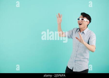 Emotional young man in anaglyph paper glasses watching movie with special effects Stock Photo