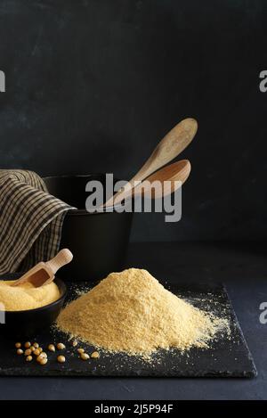 Cornmeal and corn kernels on a black background. Stock Photo