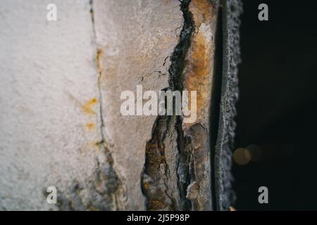 Rusted fender of a white car close-up. The effect of reagents in winter on an unprotected car body. rotten metal Stock Photo