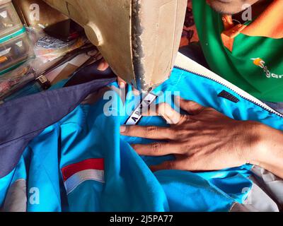 close up of hands sewing clothes Stock Photo