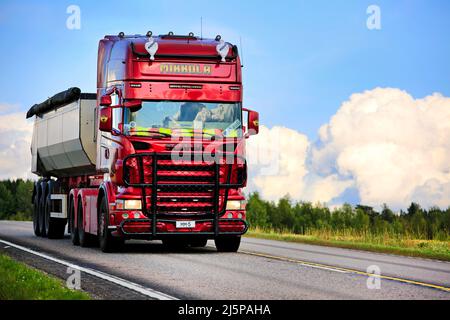 Red customized Scania truck Mikkola in front of tipper trailer for construction on road E63. Jämsä, Finland. August 23, 2018. Copy space right. Stock Photo