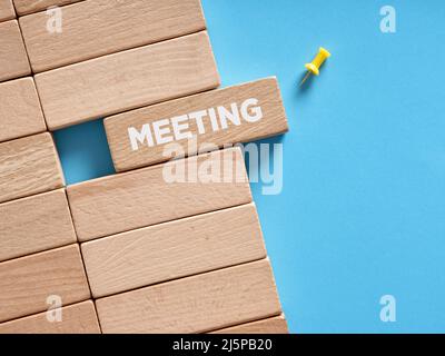 The word meeting written on wooden blocks. Business meeting reminder. Stock Photo