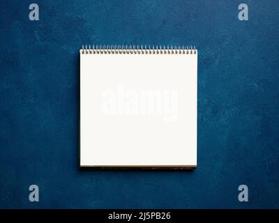 Blank or empty notebook on blue business office desktop. Stock Photo