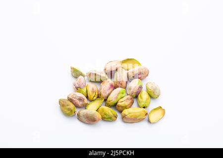 group of roasted peeled pistachios on a white background Stock Photo