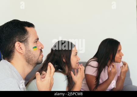 Brazil fans in front of the TV watching the soccer game at the World Cup Stock Photo