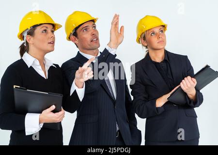 Construction workers, building site team, wearing hard hats on white background Stock Photo