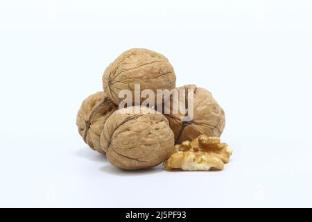 whole walnuts and walnut kernel isolated on white background. Stock Photo