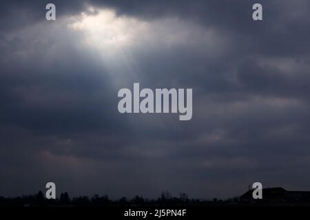 sky with a divine rays of light coming through the clouds Stock Photo